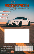 A promotional carbon display board for Scorpion Carbon Plus with a background featuring a white sports car on a road